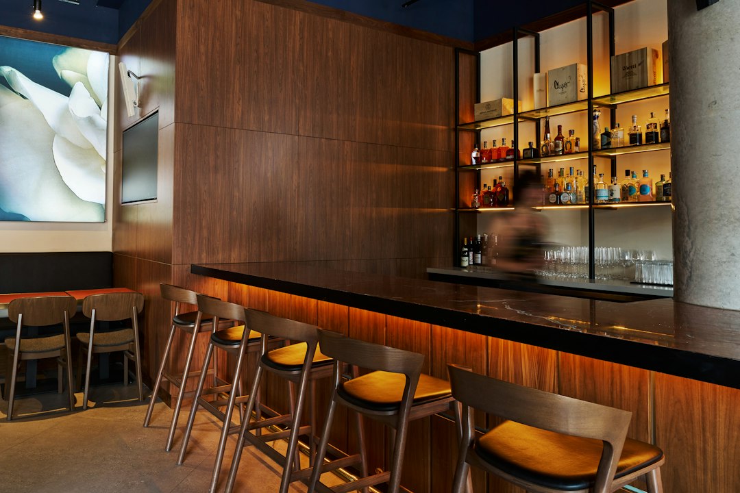 A bar with a bunch of stools in front of it