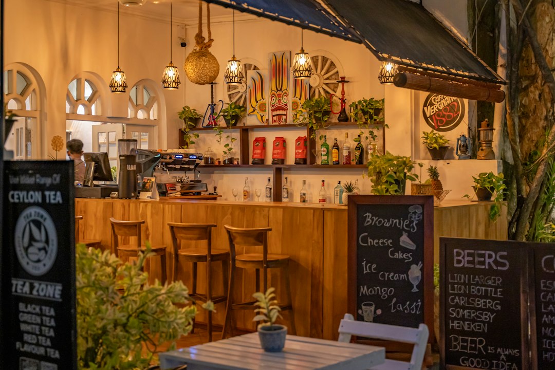 An inviting outdoor cafe with warm lighting and wooden bar