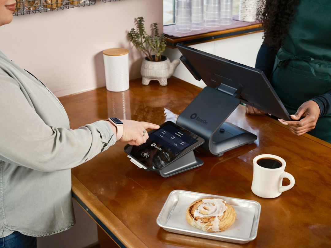 Customer paying with card at coffee shop counter