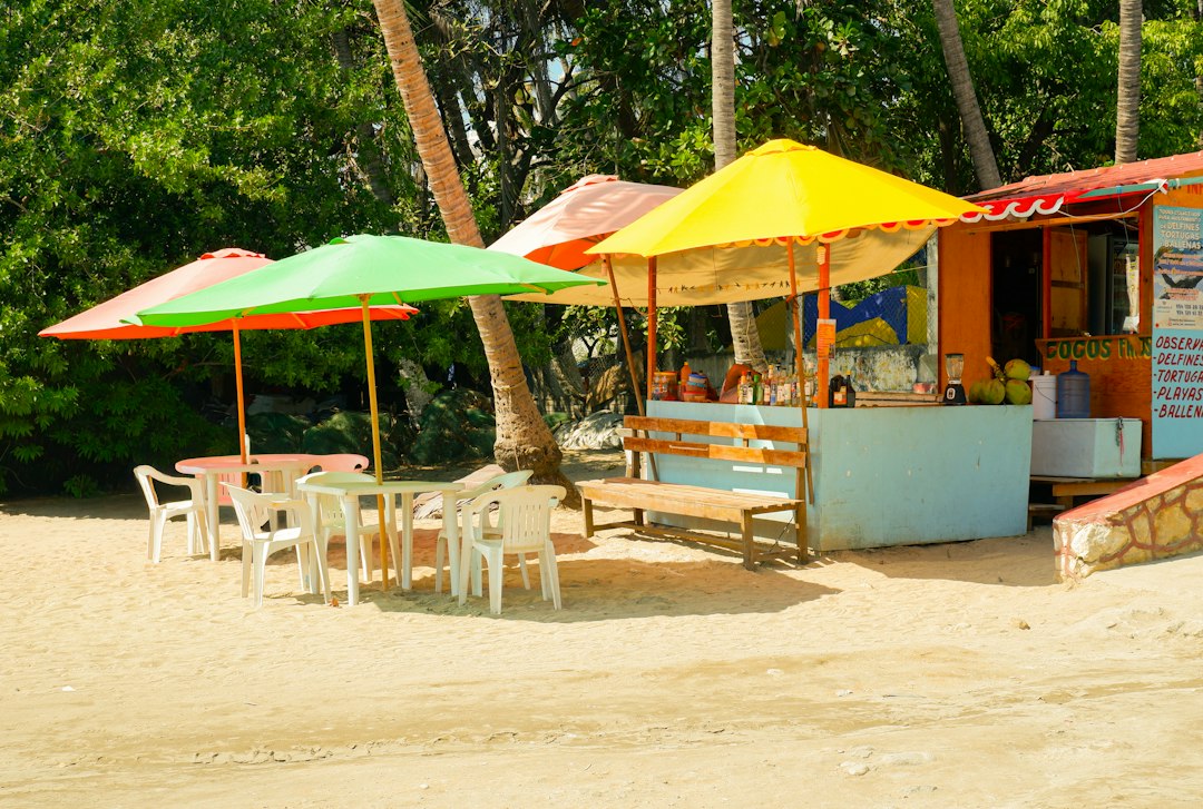 Colorful beach umbrellas and a snack shack on sandy shore