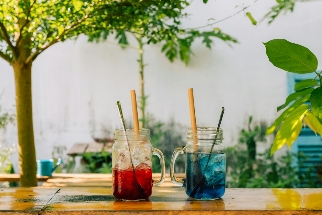 a couple of jars filled with drinks sitting on top of a table