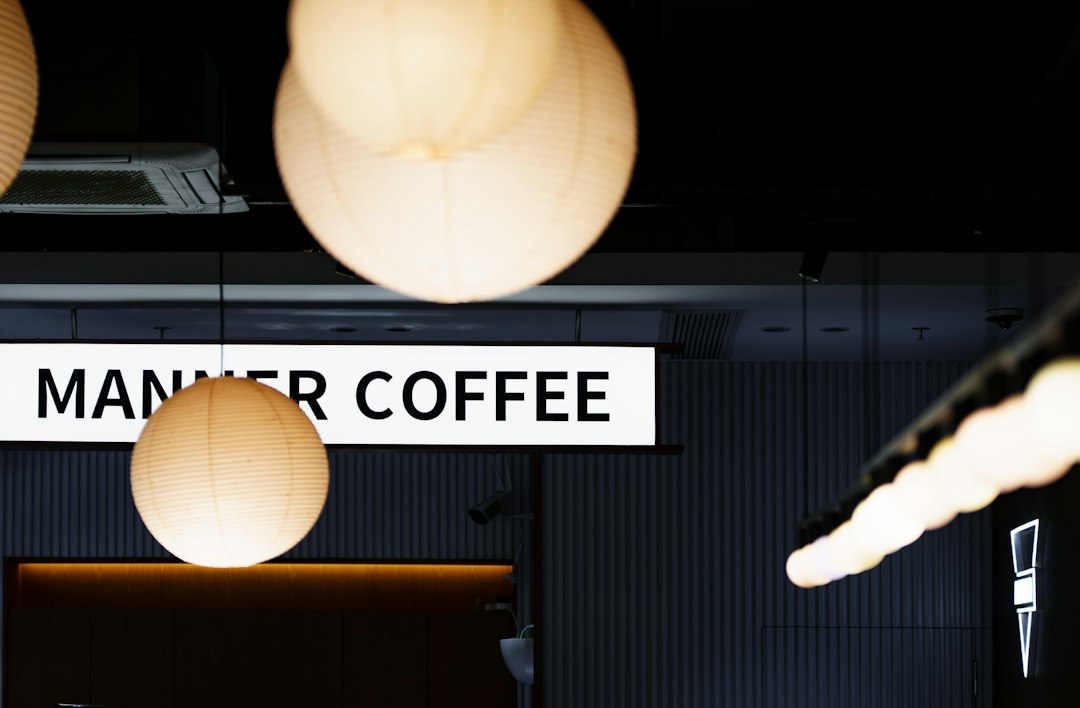 Modern interior with hanging lamps and manner coffee sign