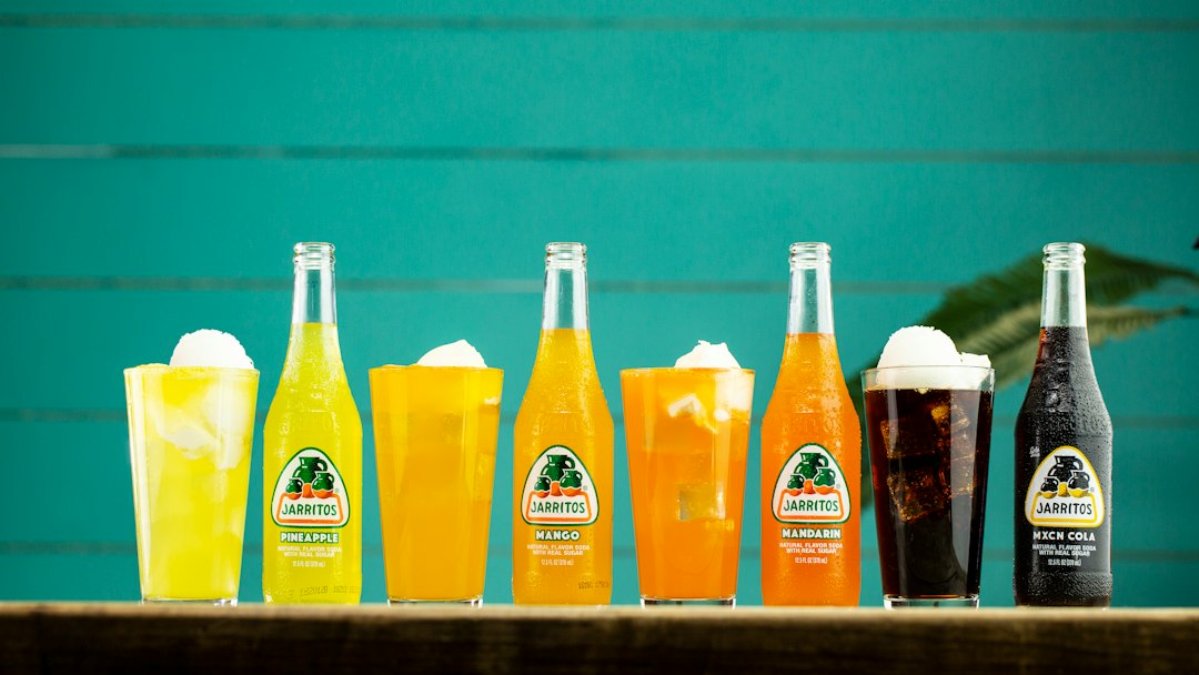 three orange juice bottles on shelf