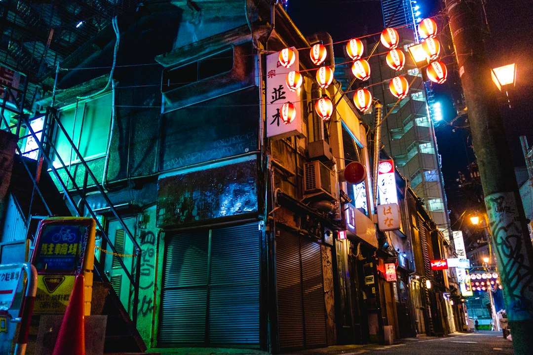 red lanterns across japanese alley at night