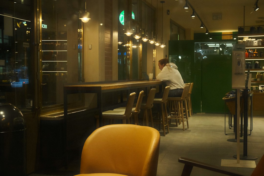Person sitting alone at a cafe counter